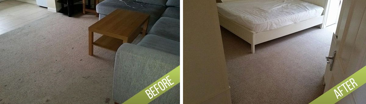 The image is divided into two sections showing a comparison of a living room area before and after professional cleaning. In the "before" section, the carpeted floor appears dull and dusty with small debris visible near the front of a grey fabric sofa, which has rounded armrests. A wooden coffee table with a lower shelf is positioned centrally, and part of an entertainment unit or TV stand is visible in the background. The room contains a grey upholstered sofa, and the overall atmosphere suggests prior use with some unevenness in the carpet surface. In the "after" section, the carpet is noticeably cleaner and more evenly colored, with a brighter appearance, indicating it has been cleaned thoroughly. The room remains the same with a white bed or mattress visible near the open door, which is partially shown on the right, enhancing the clarity of a well-maintained living or bedroom area typical for residential cleaning services. The natural light coming through the window illuminates the space, highlighting the cleanliness achieved. This comparison exemplifies the scope of professional cleaning that a company like Tidy Up could provide in Milton Keynes, specifically within the MK1 postcode, ensuring a tidy, hygienic environment in residential spaces.